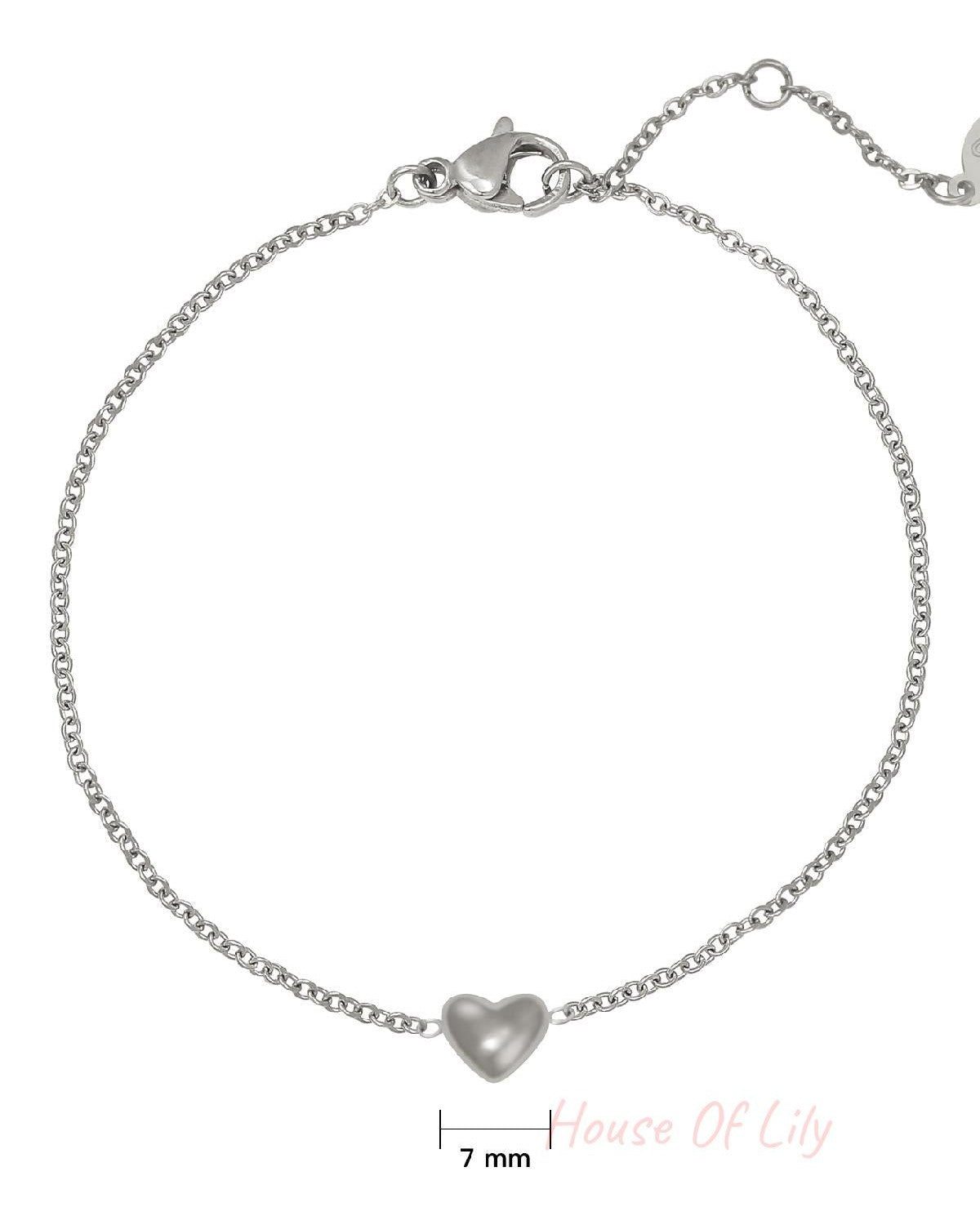 Close-up of silver chain bracelet with 7mm heart charm and lobster clasp on white background