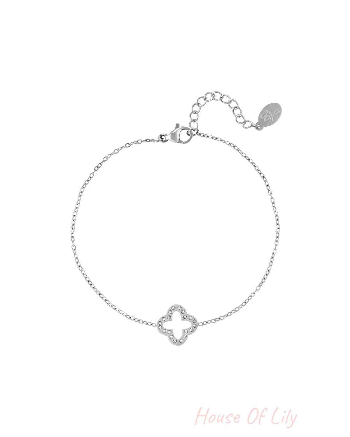 Silver clover charm bracelet with sparkling zircon stones and adjustable chain clasp on white background