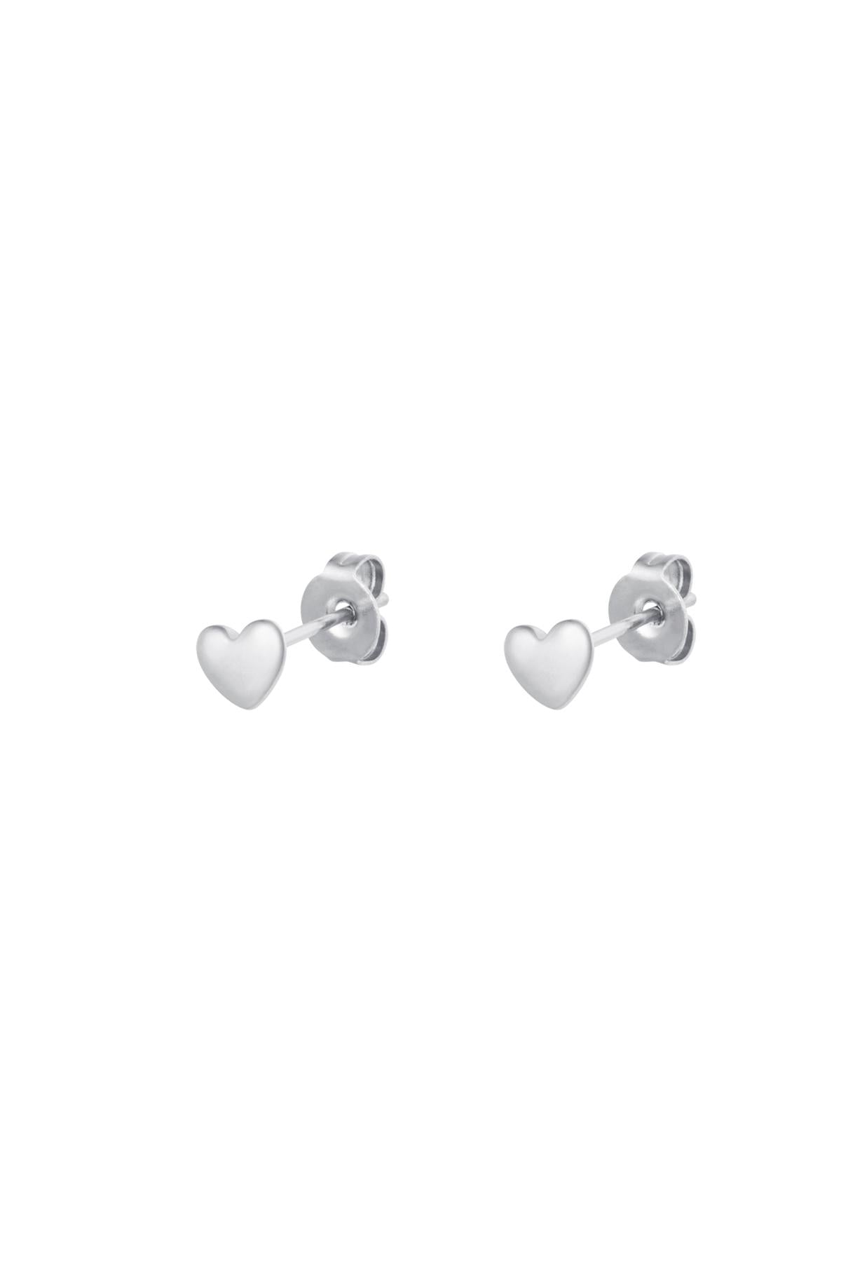 Pair of minimalist silver-tone heart-shaped stud earrings with butterfly backing on white background