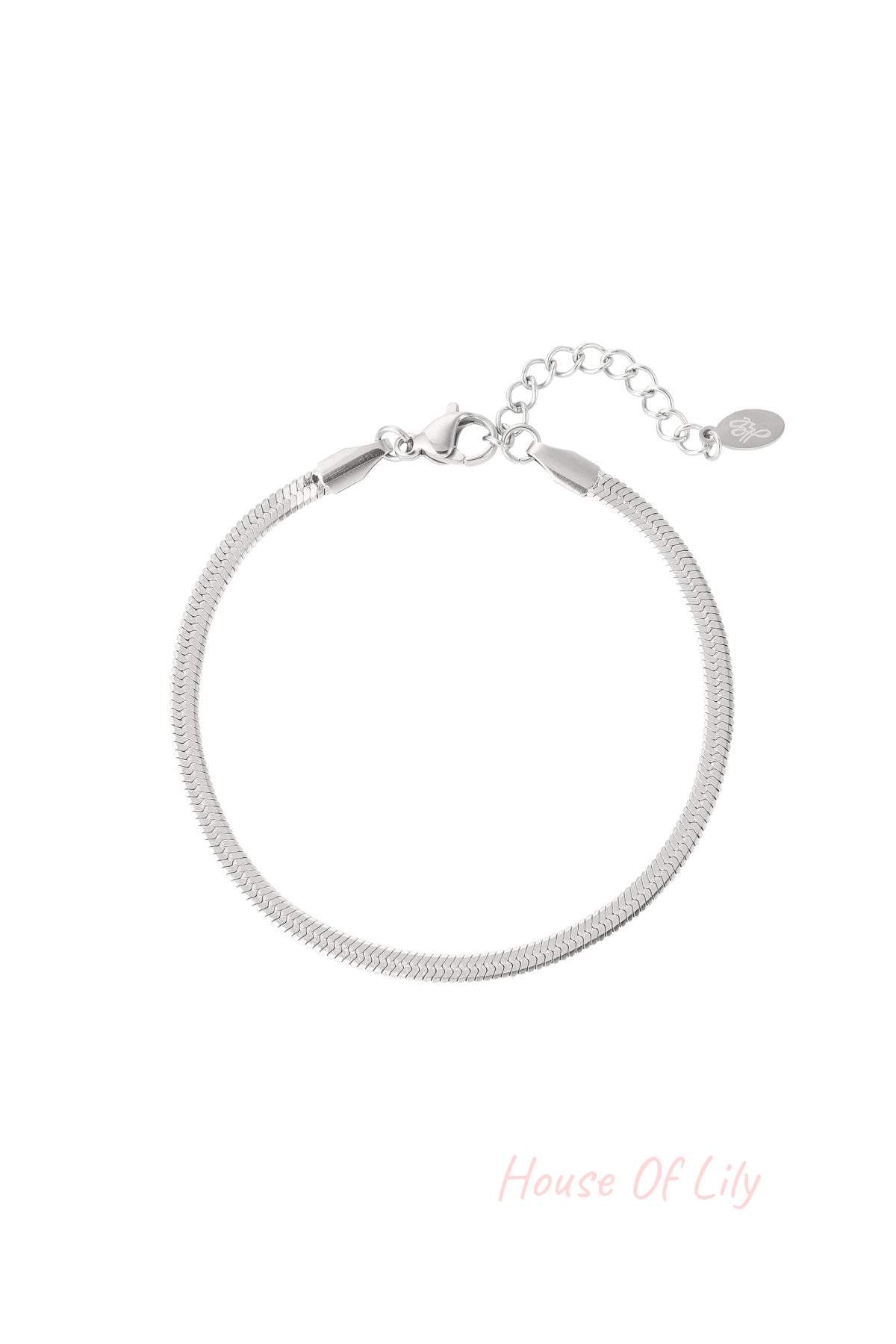 Sleek silver-tone herringbone chain bracelet with lobster clasp and adjustable extension chain on a white background