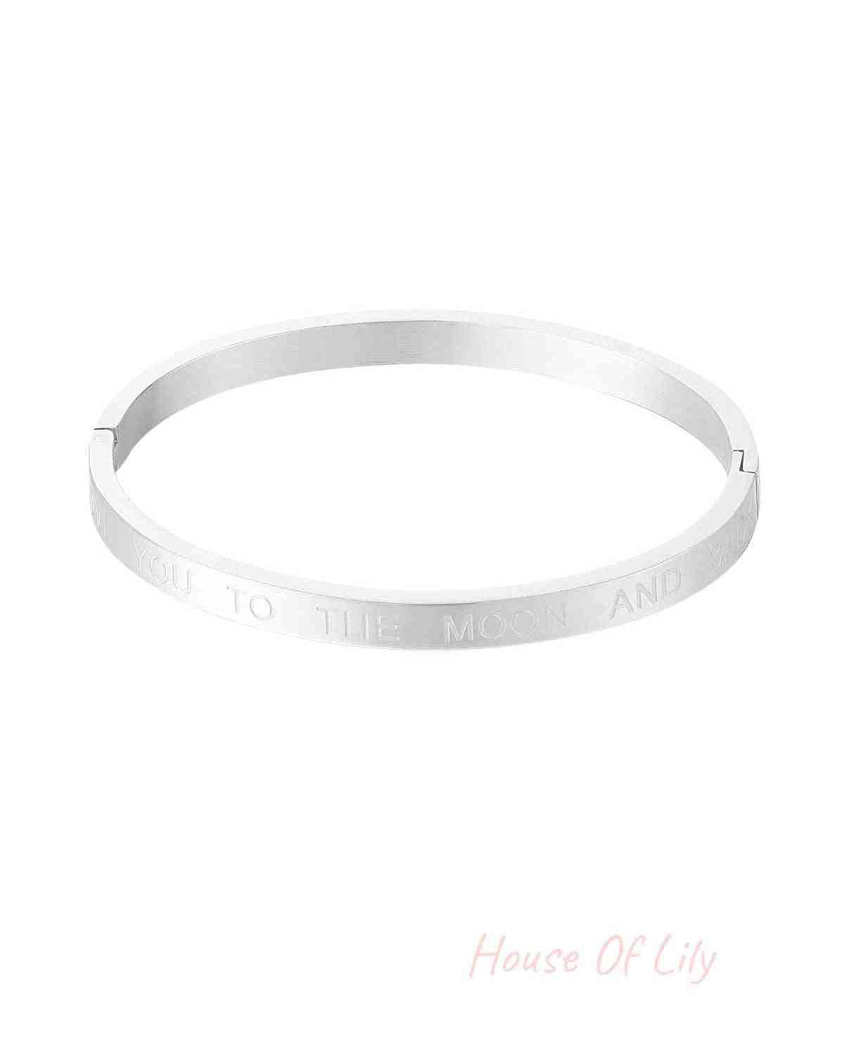Silver stainless steel bangle bracelet engraved with the phrase 'Love you to the moon and back' on white background