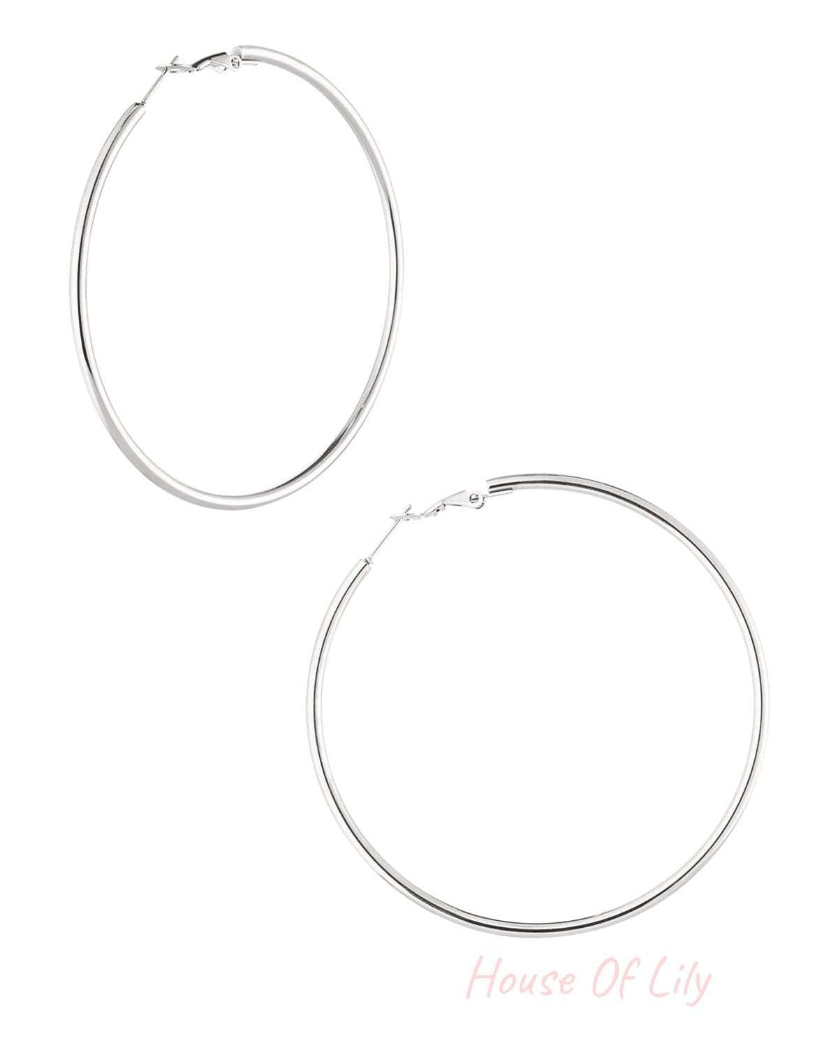 Pair of polished silver hoop earrings with snap latch closure displayed on white background