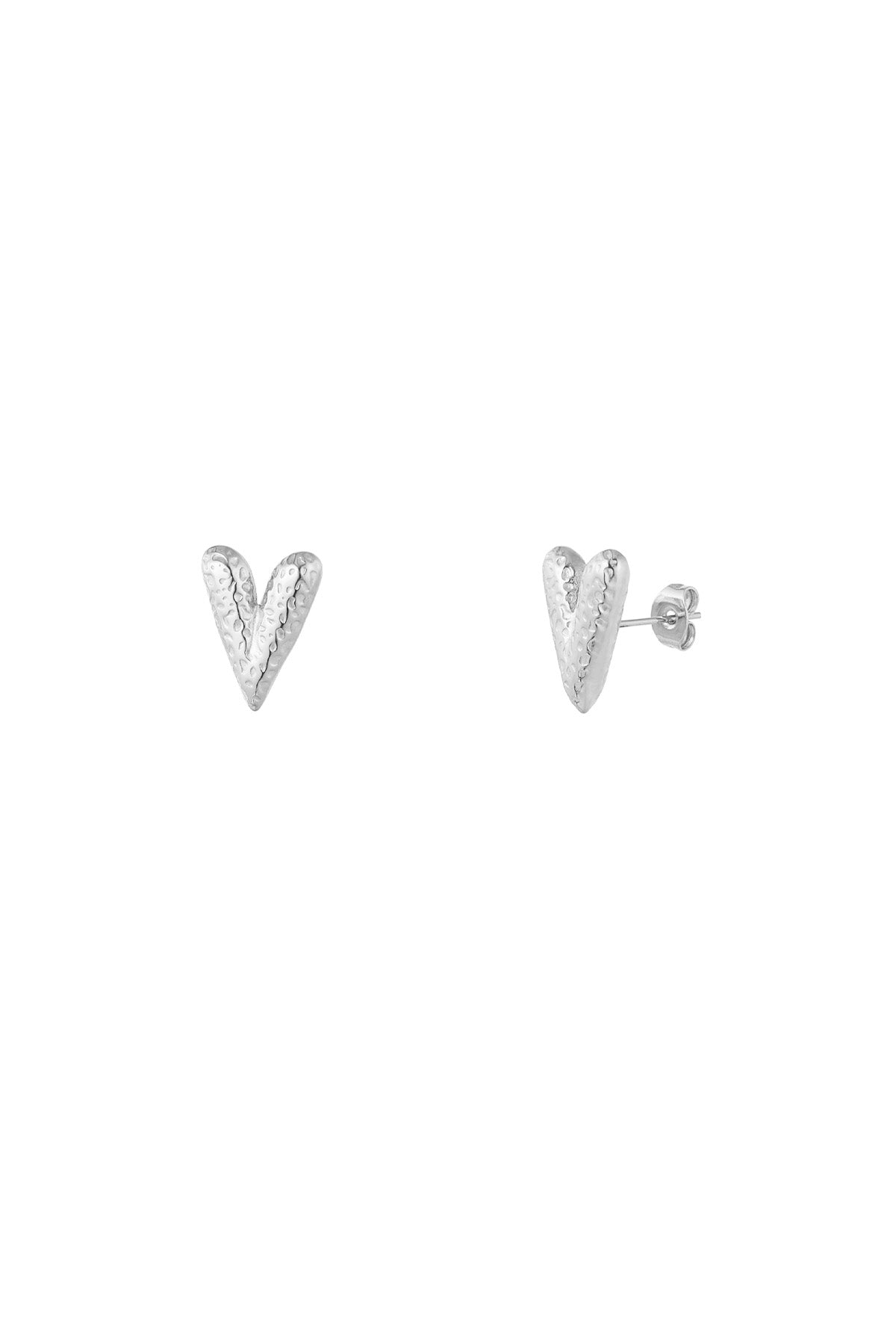 Pair of silver textured heart-shaped stud earrings with hammered finish on white background