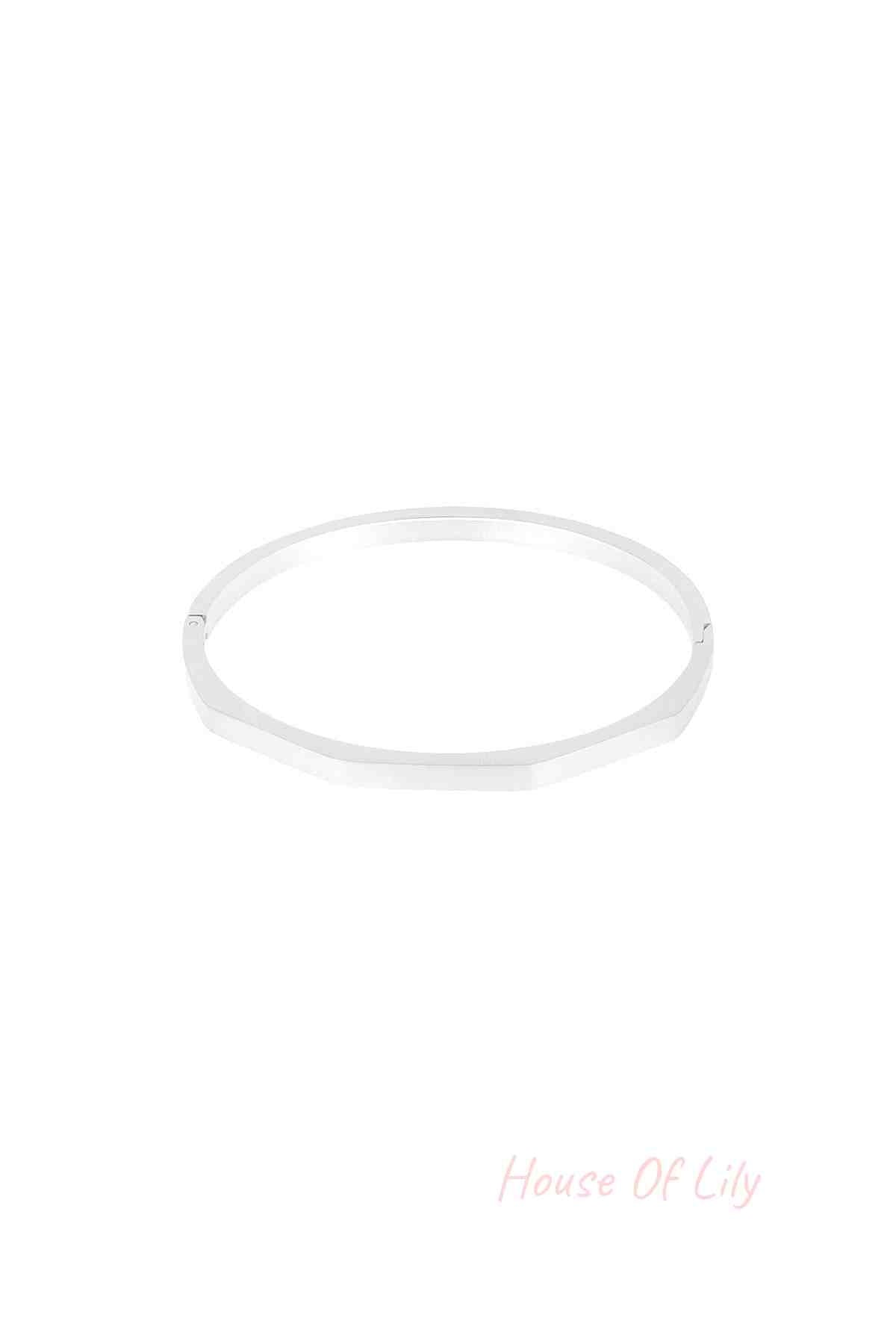 Silver hexagon-shaped bangle bracelet with a matte finish displayed on white background