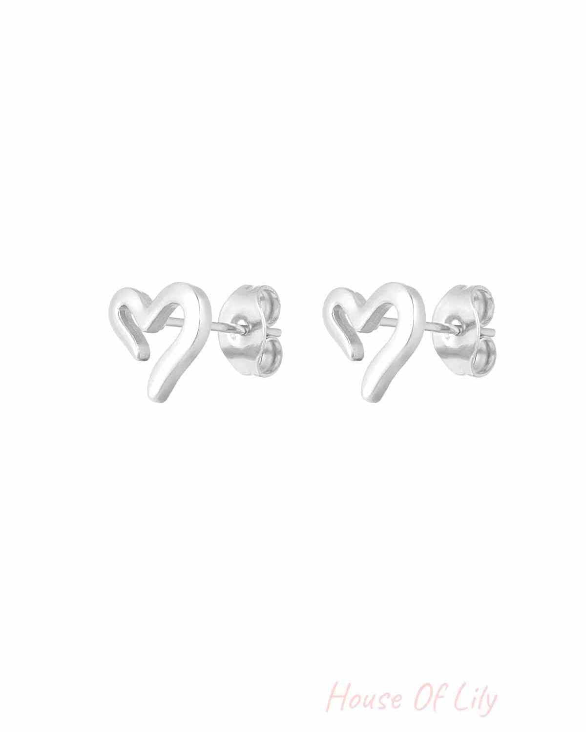 Silver-tone minimalist open heart stud earrings shown close-up with butterfly backings on white background