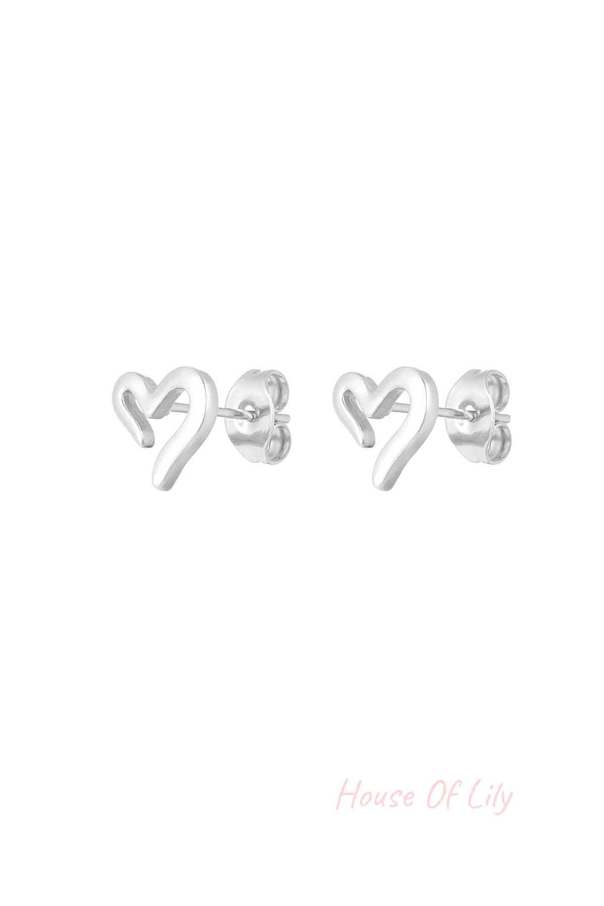 Silver-tone minimalist open heart stud earrings shown close-up with butterfly backings on white background