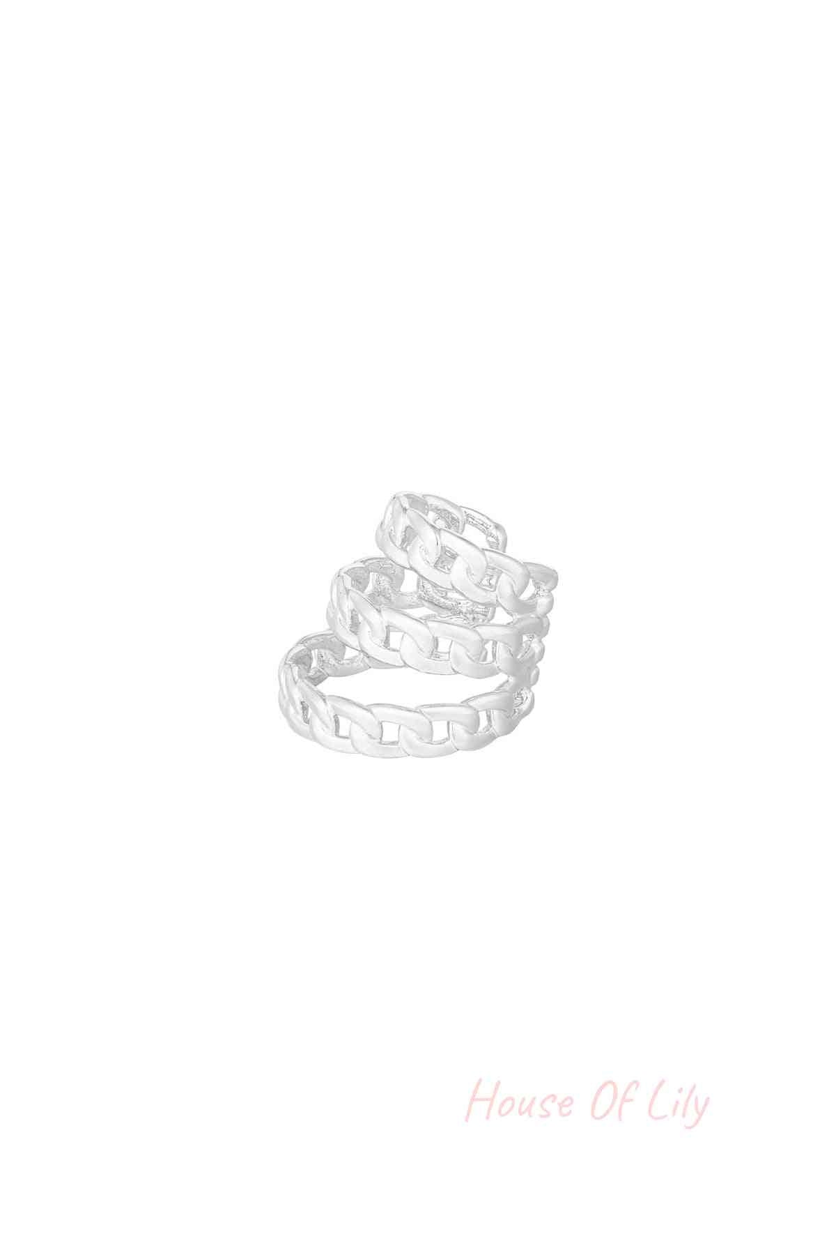 Close-up of silver layered chain link ear cuff on white background