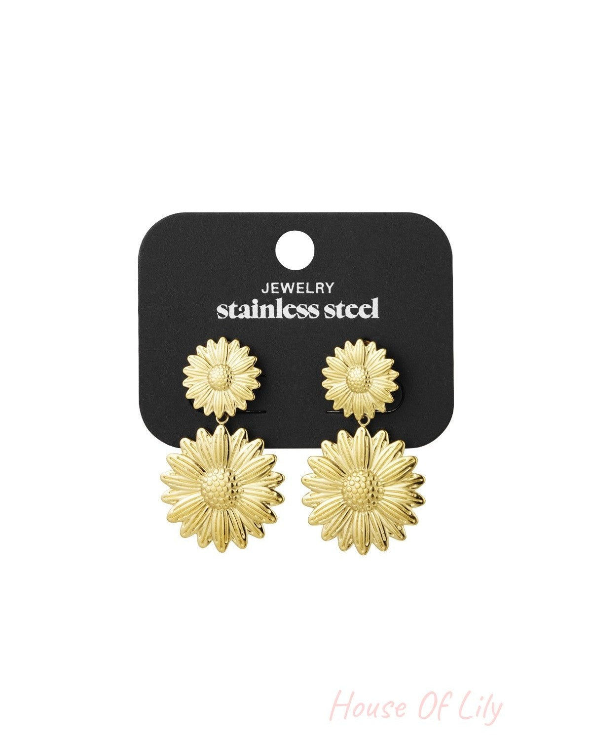 Gold sunflower drop earrings displayed on black stainless steel jewelry card