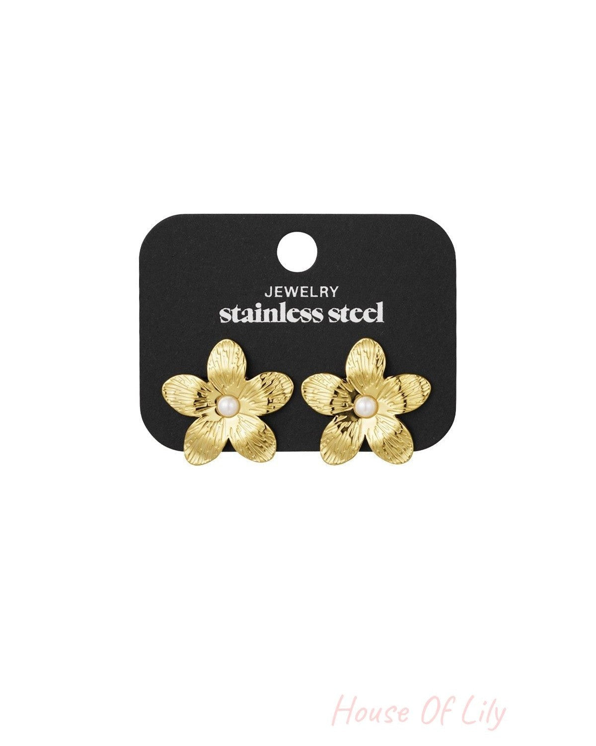Gold-tone floral pearl stud earrings displayed on a black jewelry card labeled stainless steel