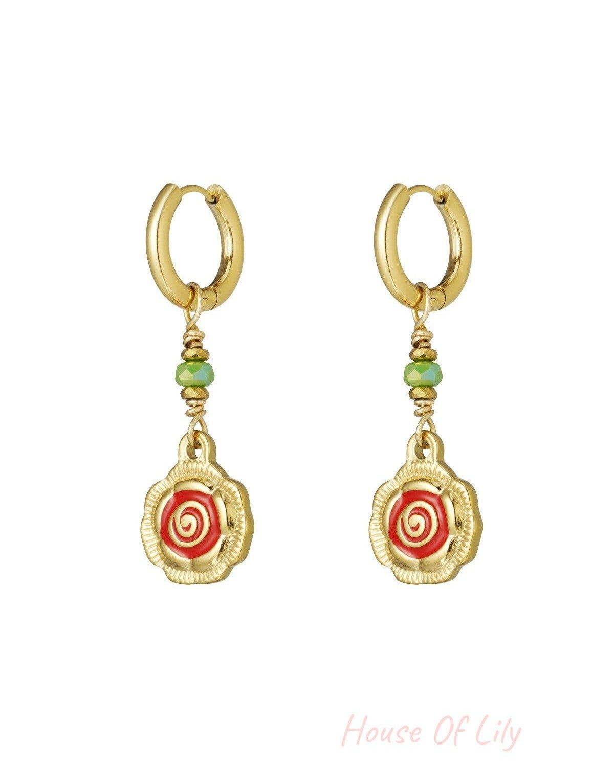 Pair of gold-tone hoop earrings with dangling spiral flower charms in red and green beads on white background
