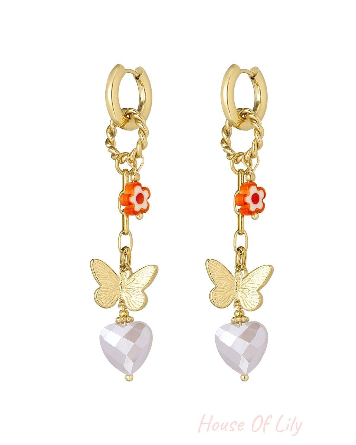 Gold drop earrings with orange flower, butterfly charm, and faceted light pink heart pendant on white background