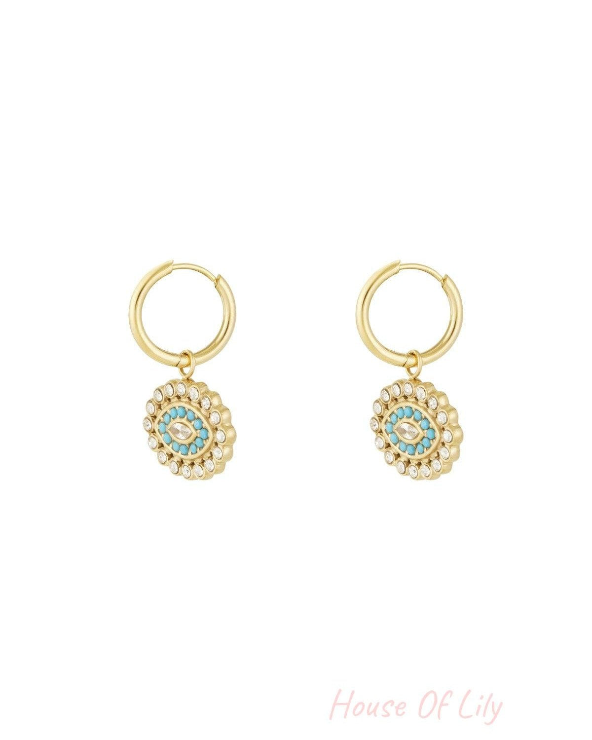 Gold stainless steel hoop earrings with turquoise and rhinestone evil eye charms on white background