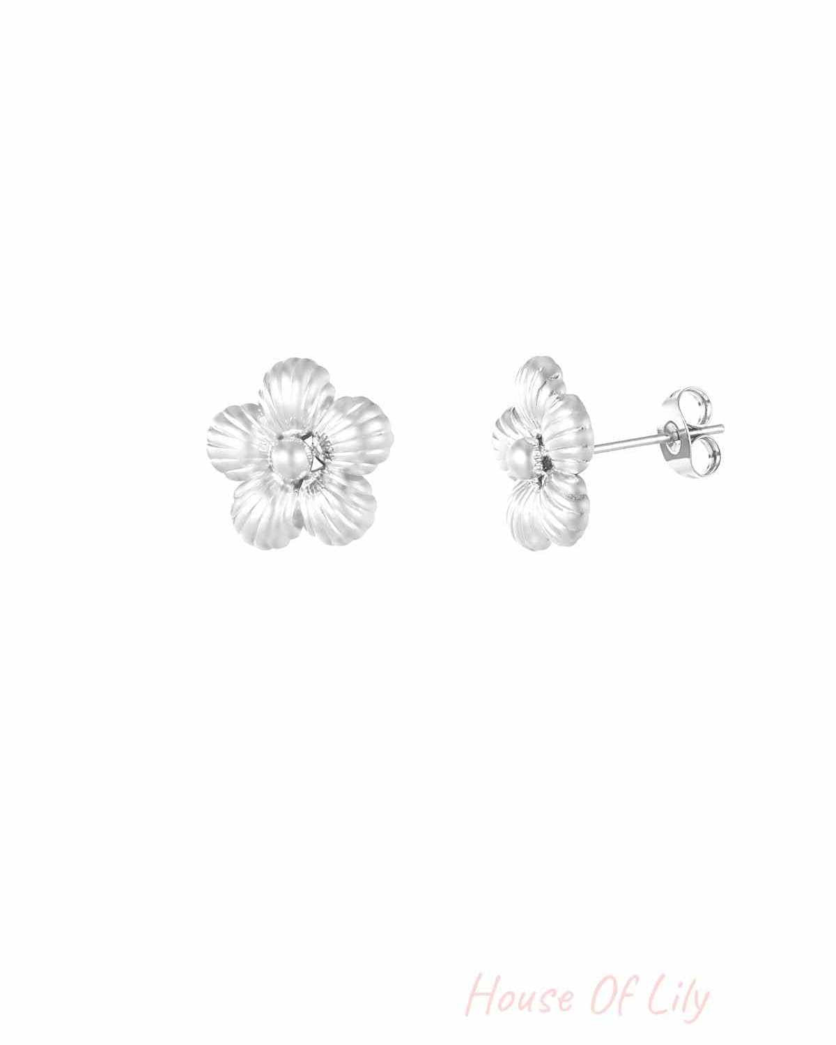 Silver fluted flower stud earrings shown on white background