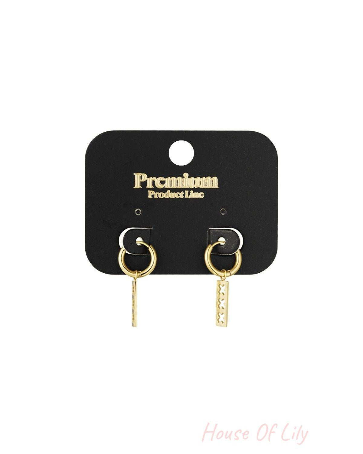 Gold-toned triple cross bar drop earrings displayed on black Premium Product Line card