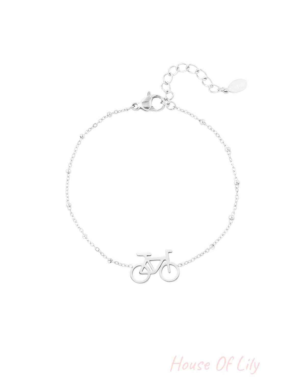 Silver bicycle charm bracelet with delicate beaded chain and extender clasp on white background
