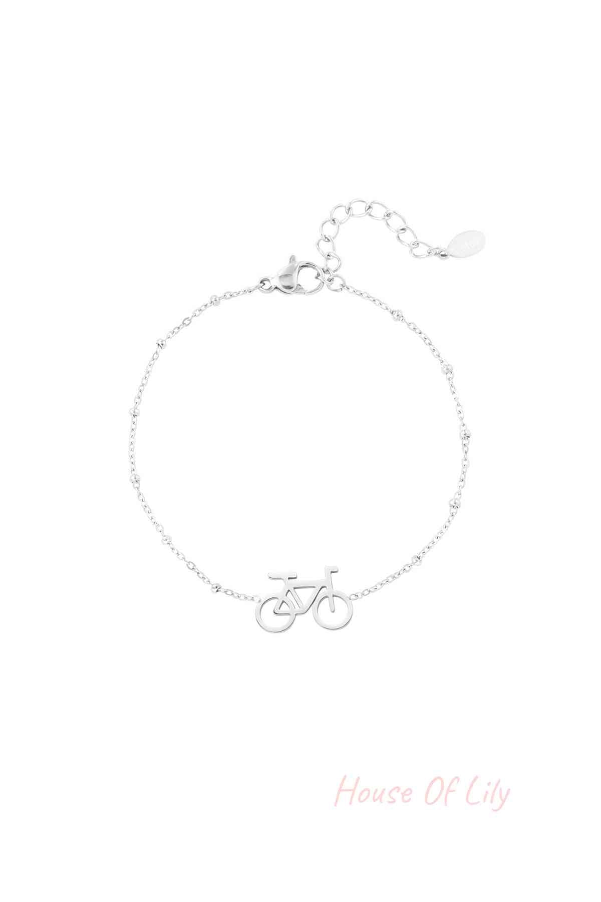 Silver bicycle charm bracelet with delicate beaded chain and extender clasp on white background