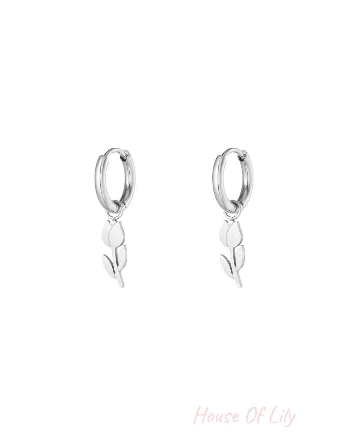 Pair of silver minimalist tulip drop hoop earrings on white background