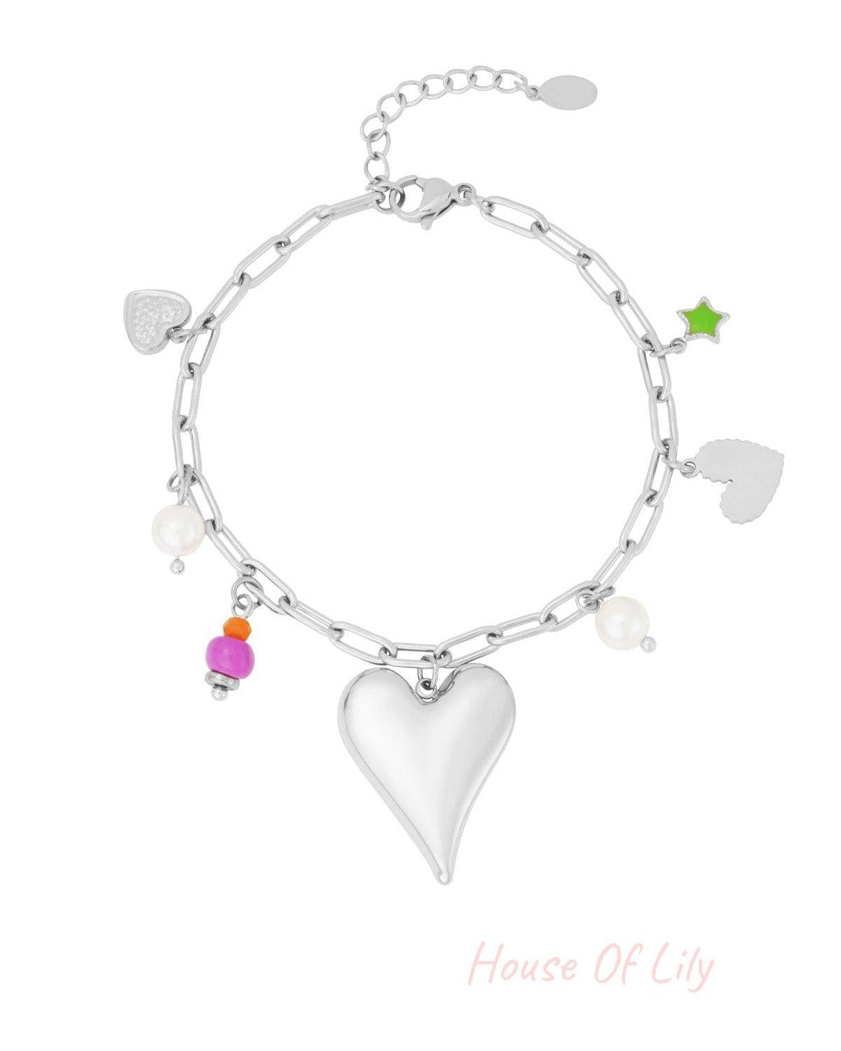 Silver-tone charm bracelet with heart pendant, colourful beads, enamel star and faux pearls on chain, isolated on white background
