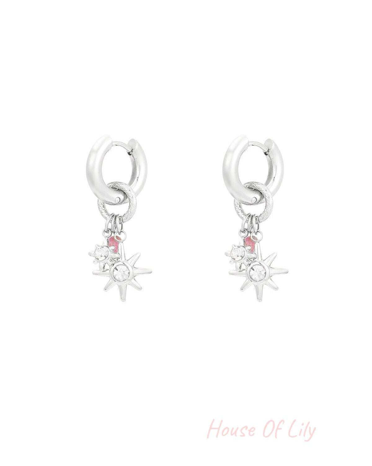 Silver-tone starlight charm hoop earrings with clear rhinestone stars on white background