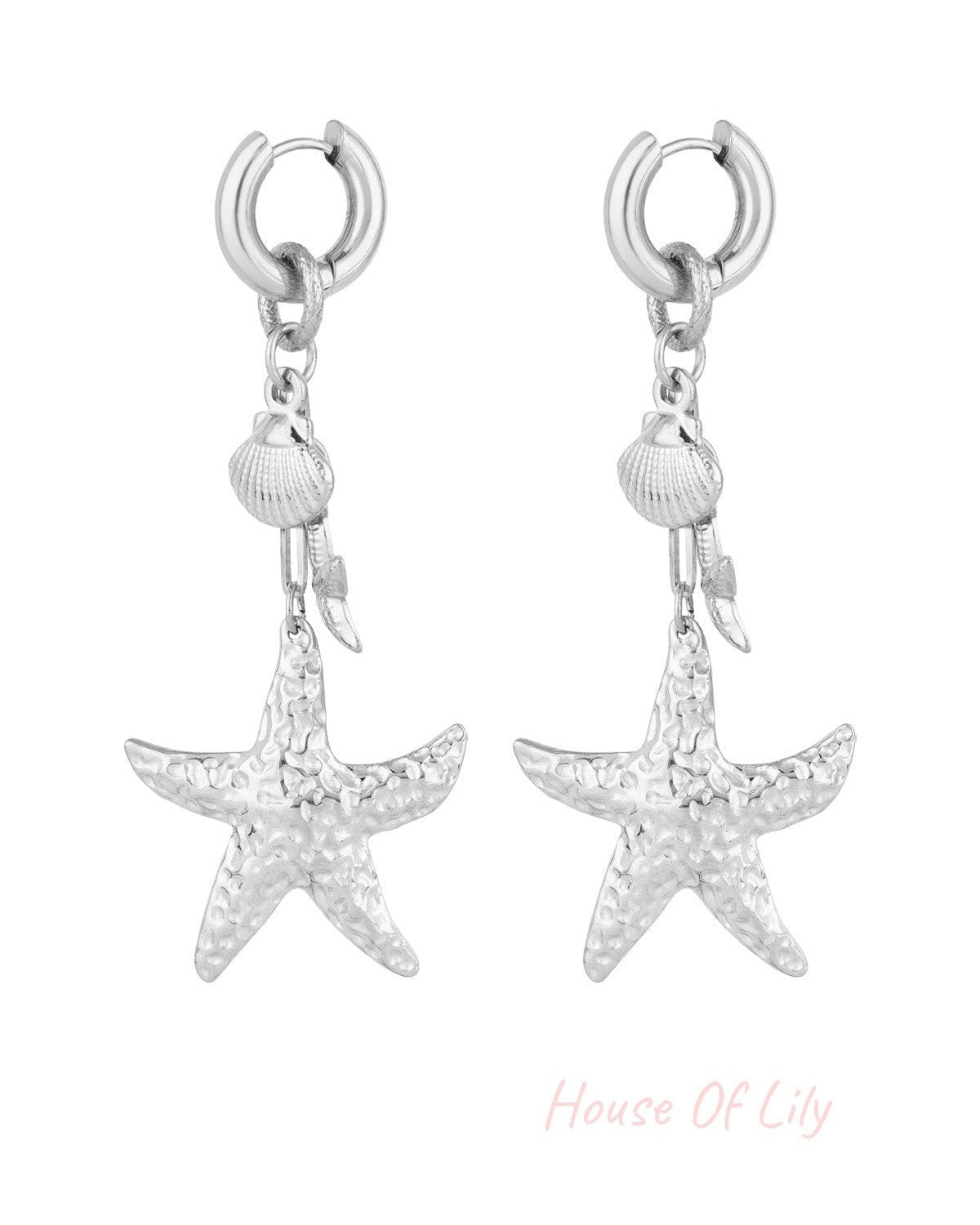 Pair of silver-tone hammered starfish and seashell drop earrings on white background