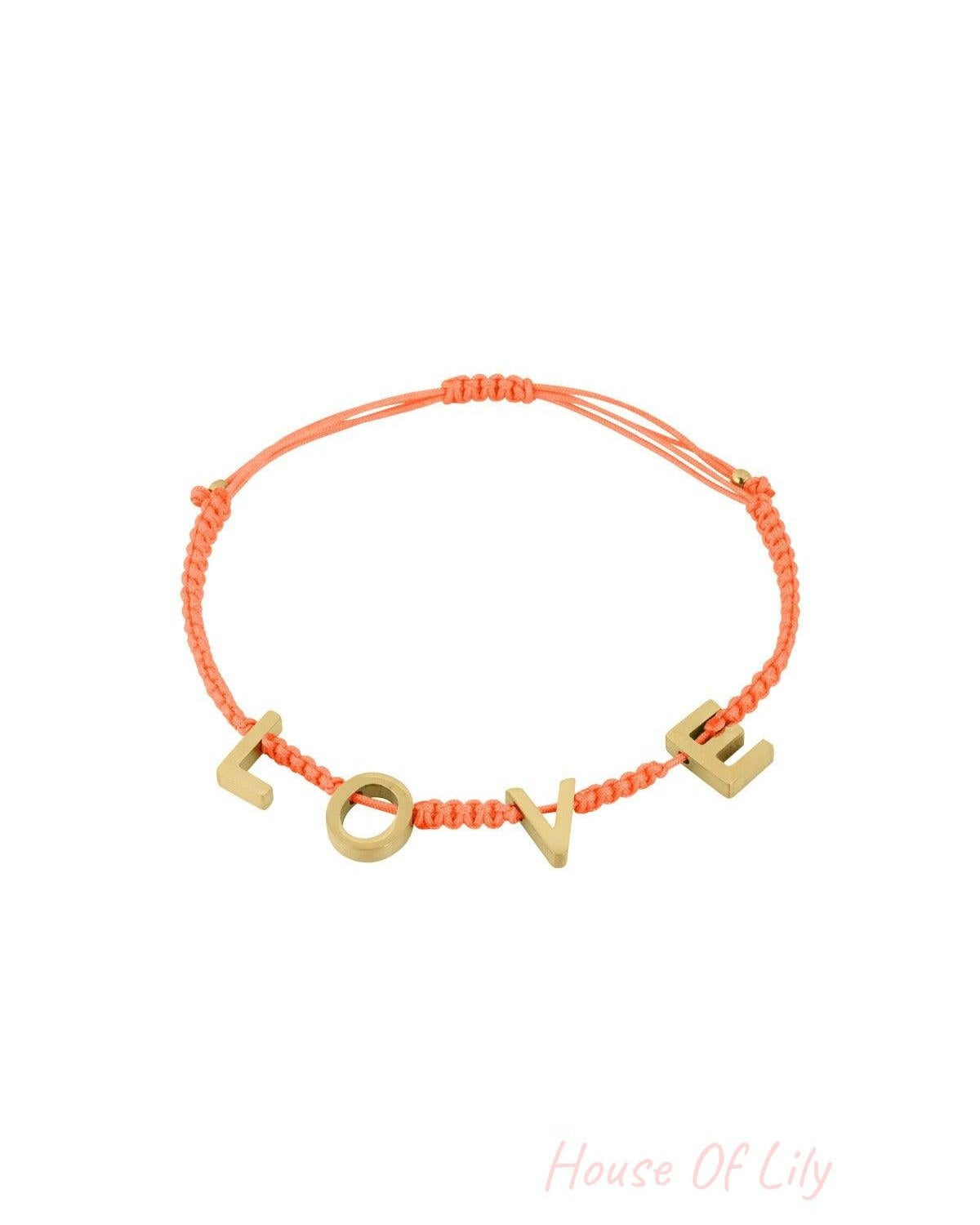 Coral orange braided LOVE bracelet with polished gold letters shown against white background