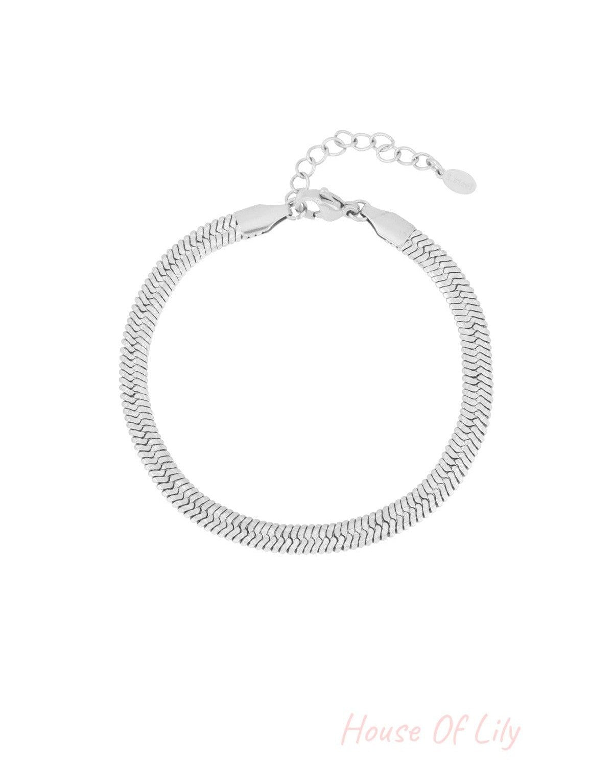 Silver-toned snake chain bracelet with adjustable clasp on white background