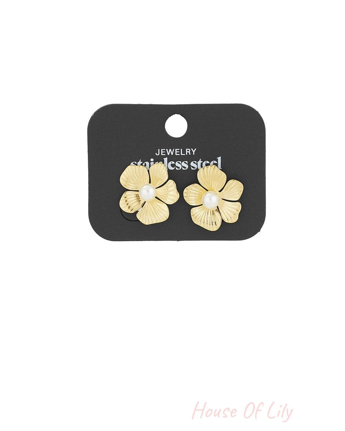 Pair of gold floral pearl stud earrings displayed on a black jewelry card labeled stainless steel
