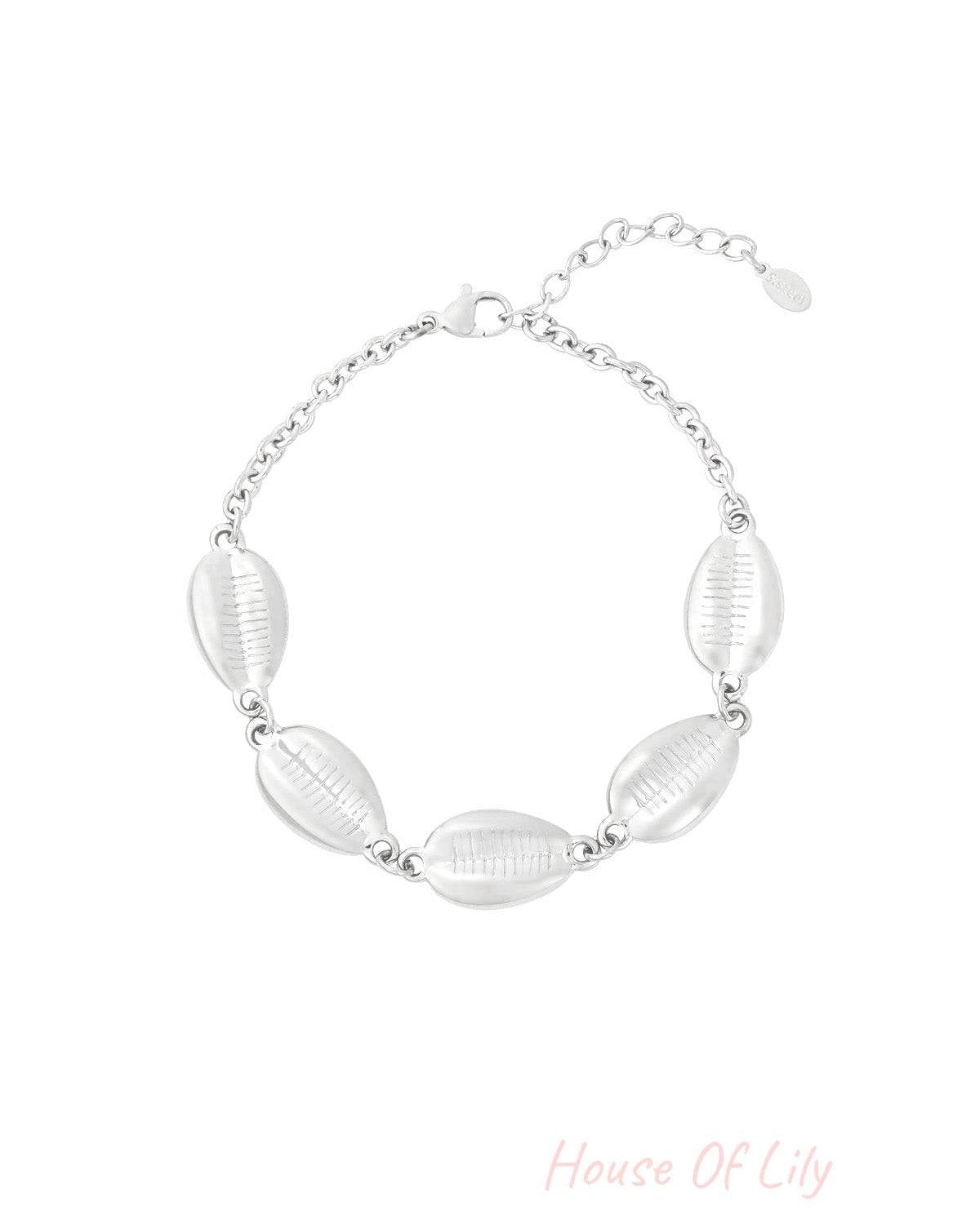 Silver-tone shell charm bracelet with adjustable lobster clasp against a white background, showing polished shells and fine chain design