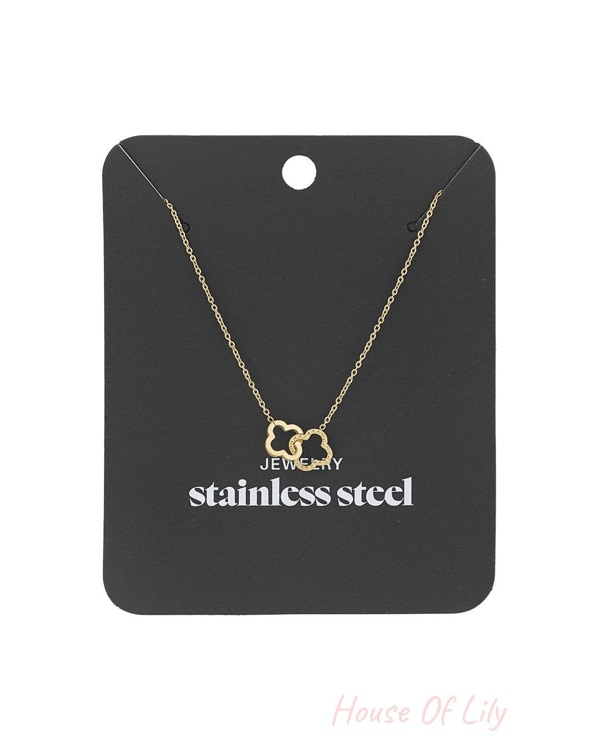 Gold interlinked clover pendant necklace displayed on black stainless steel jewellery card