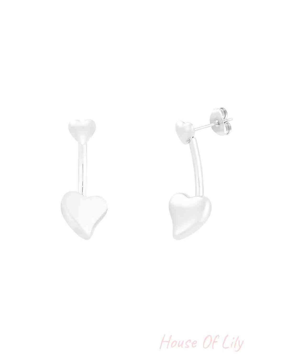 Close-up of silver double heart drop earrings with small heart stud and larger heart drop