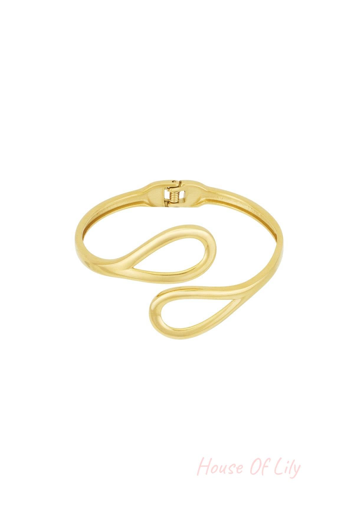 Gold-toned cuff bracelet with open loop design on white background