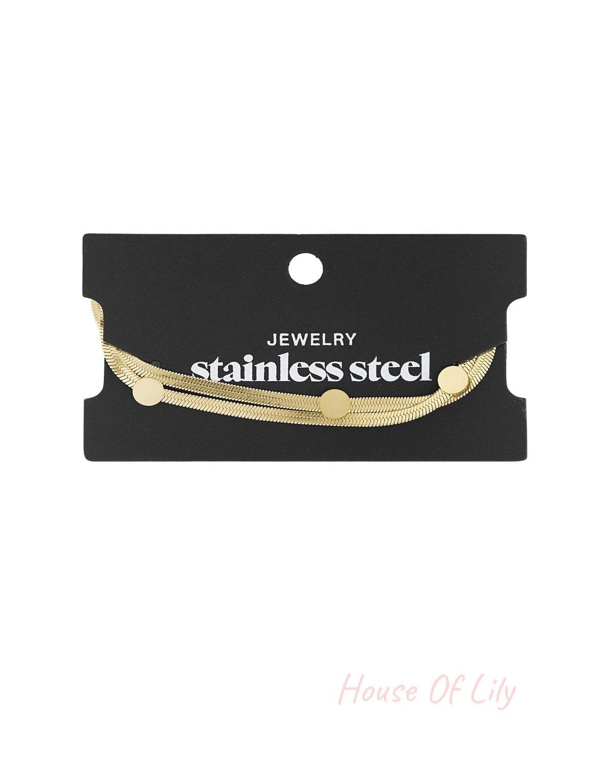 Gold-tone stainless steel flat chain bracelet with dot accents displayed on black card labelled stainless steel jewellery