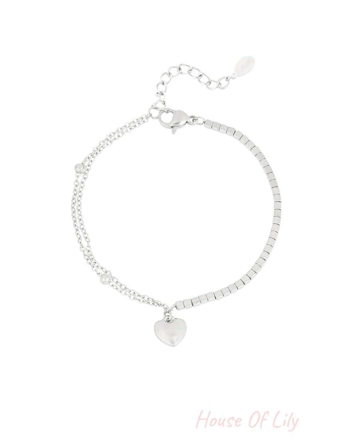 Silver stainless steel heart charm bracelet with mixed chain and square beads design on white background