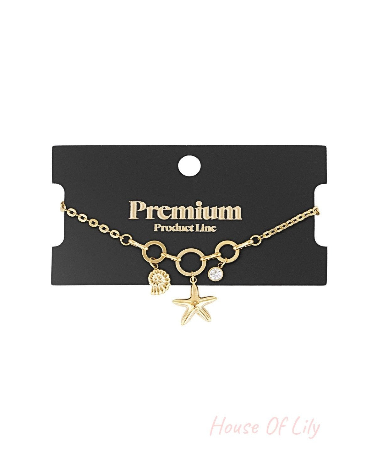 Gold-tone charm bracelet displayed on black Premium Product Line card