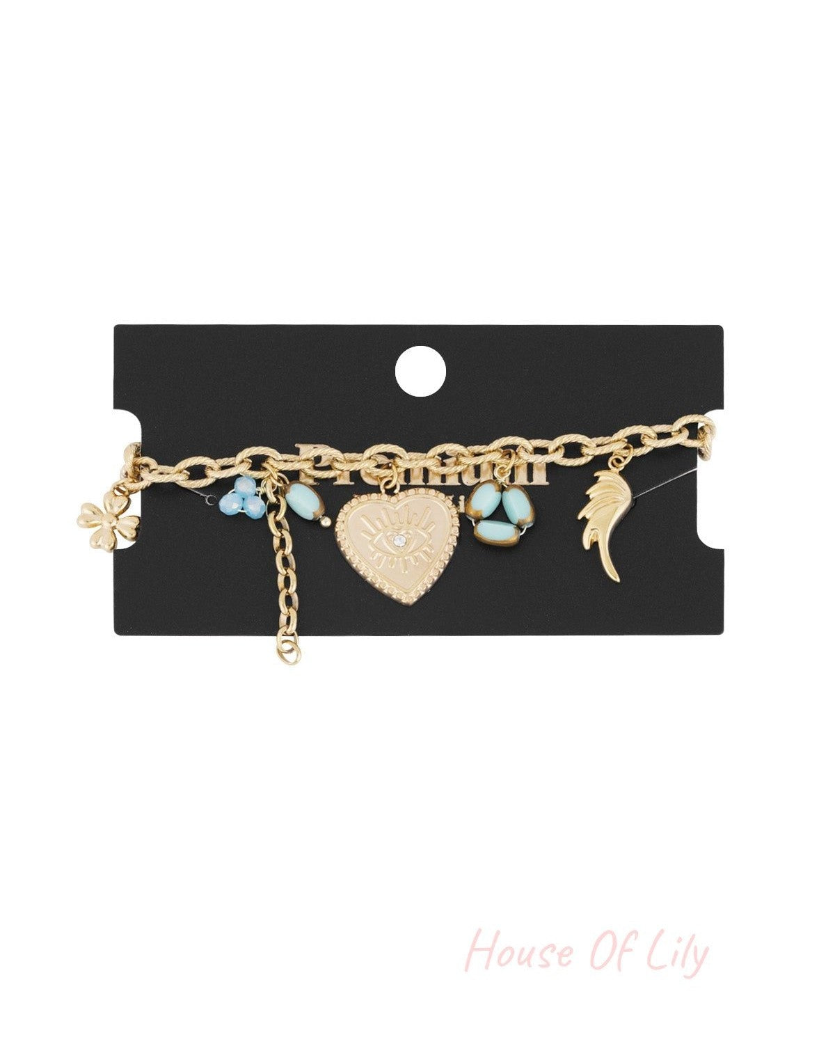 Golden charm bracelet displayed on a black branded card showcasing the linked chain and colorful charms against a white background