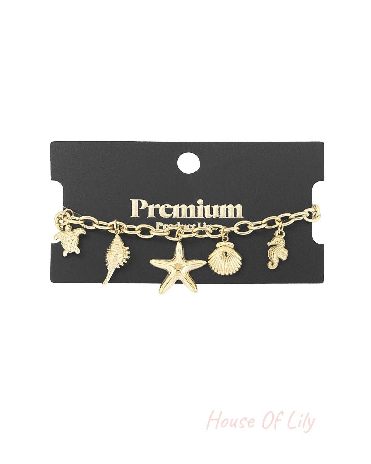 Gold sea charm bracelet displayed on a black Premium product card showing the starfish, turtle, seahorse, shell, and conch charms clearly