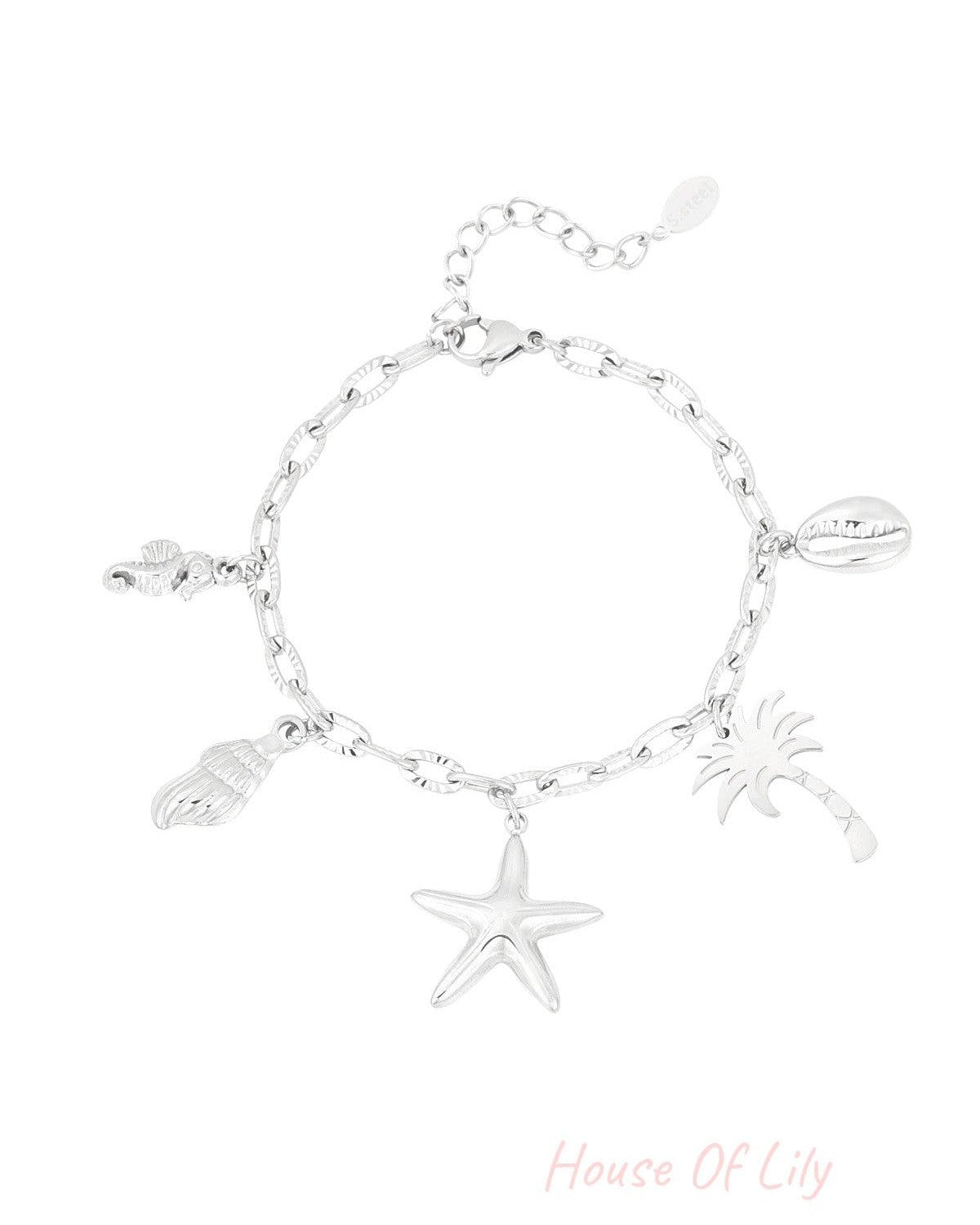 Silver beach charm bracelet with starfish, palm tree, seashell, seahorse and cowrie shell charms on textured link chain