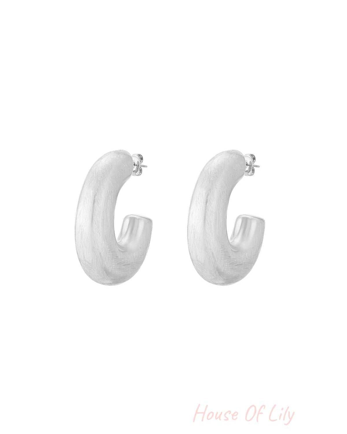Cloud Nine silver-tone brushed metal chunky hoop earrings with a thick, C-shaped design on a white background.