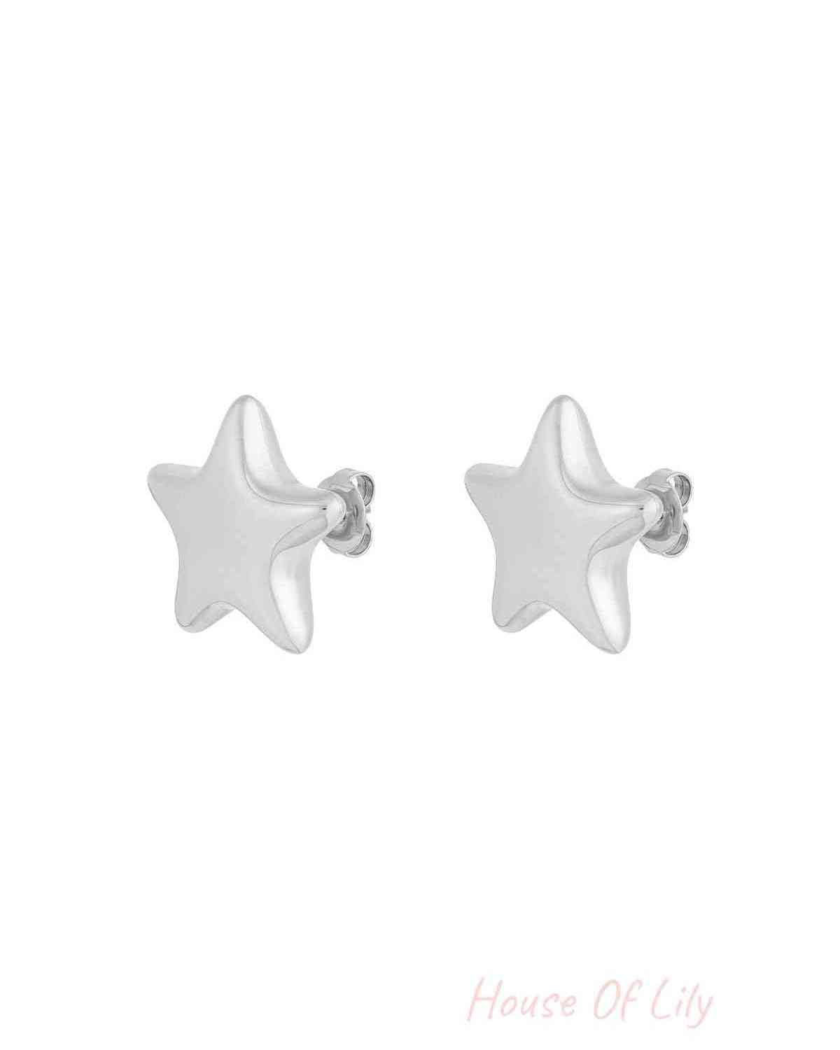 Close-up of silver star-shaped stud earrings with butterfly backs on a white background