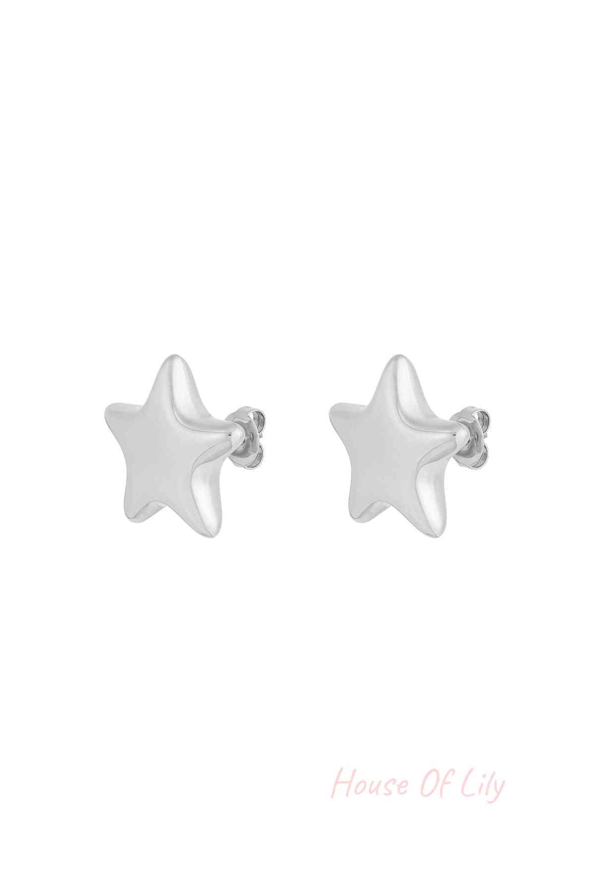 Close-up of silver star-shaped stud earrings with butterfly backs on a white background