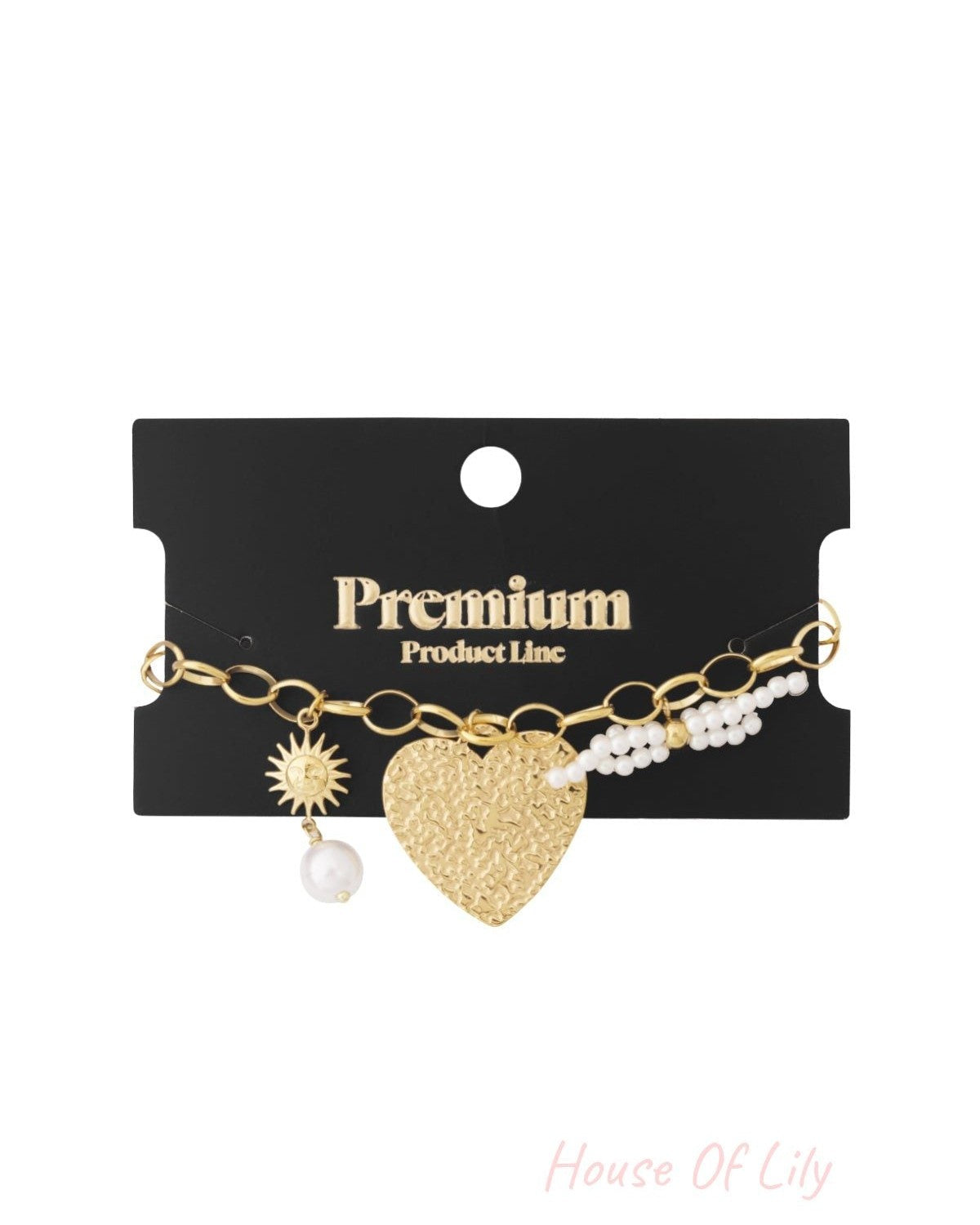 Gold-tone charm bracelet displayed on a black card labeled Premium Product Line, featuring heart, sun, and pearl charms