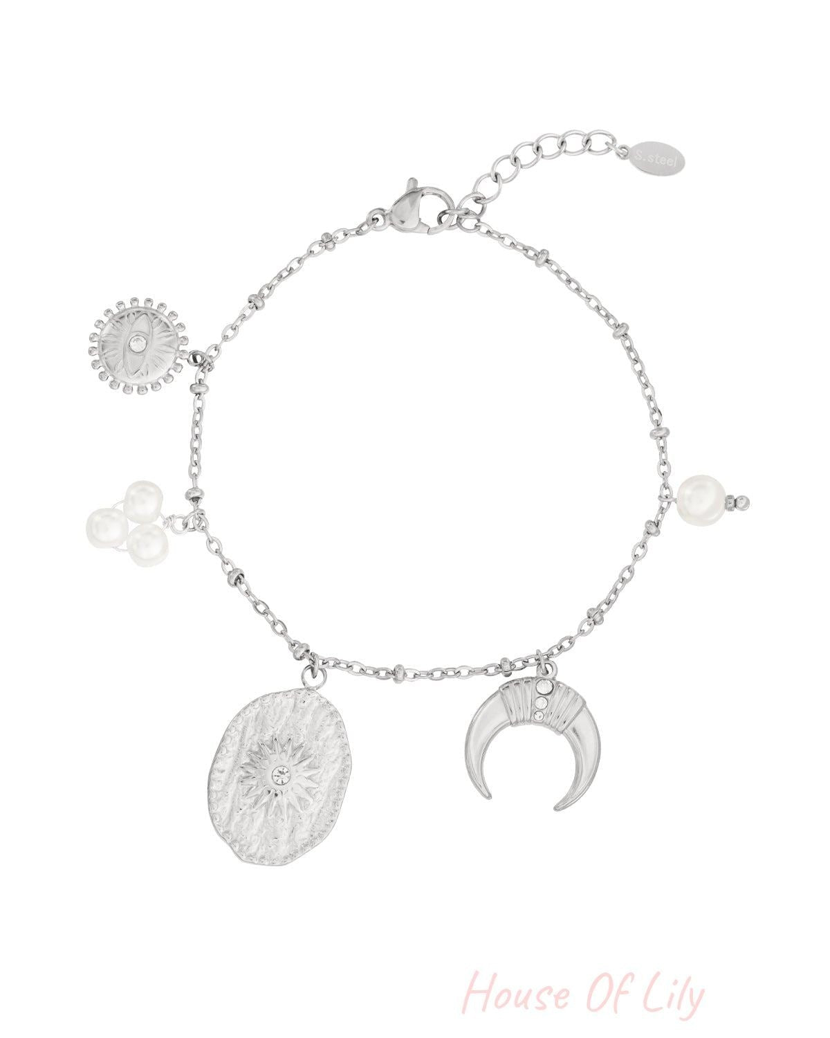 Silver charm bracelet featuring a crescent moon, sunburst medallion, evil eye, and pearl cluster on a delicate chain.