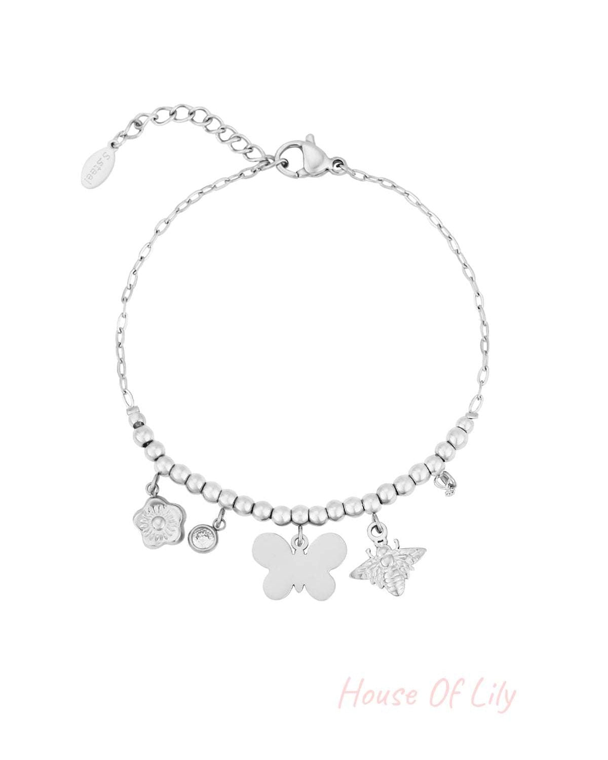 Silver-tone beaded charm bracelet with butterfly, bee, flower, crystal, and pearl charms displayed flat on white background