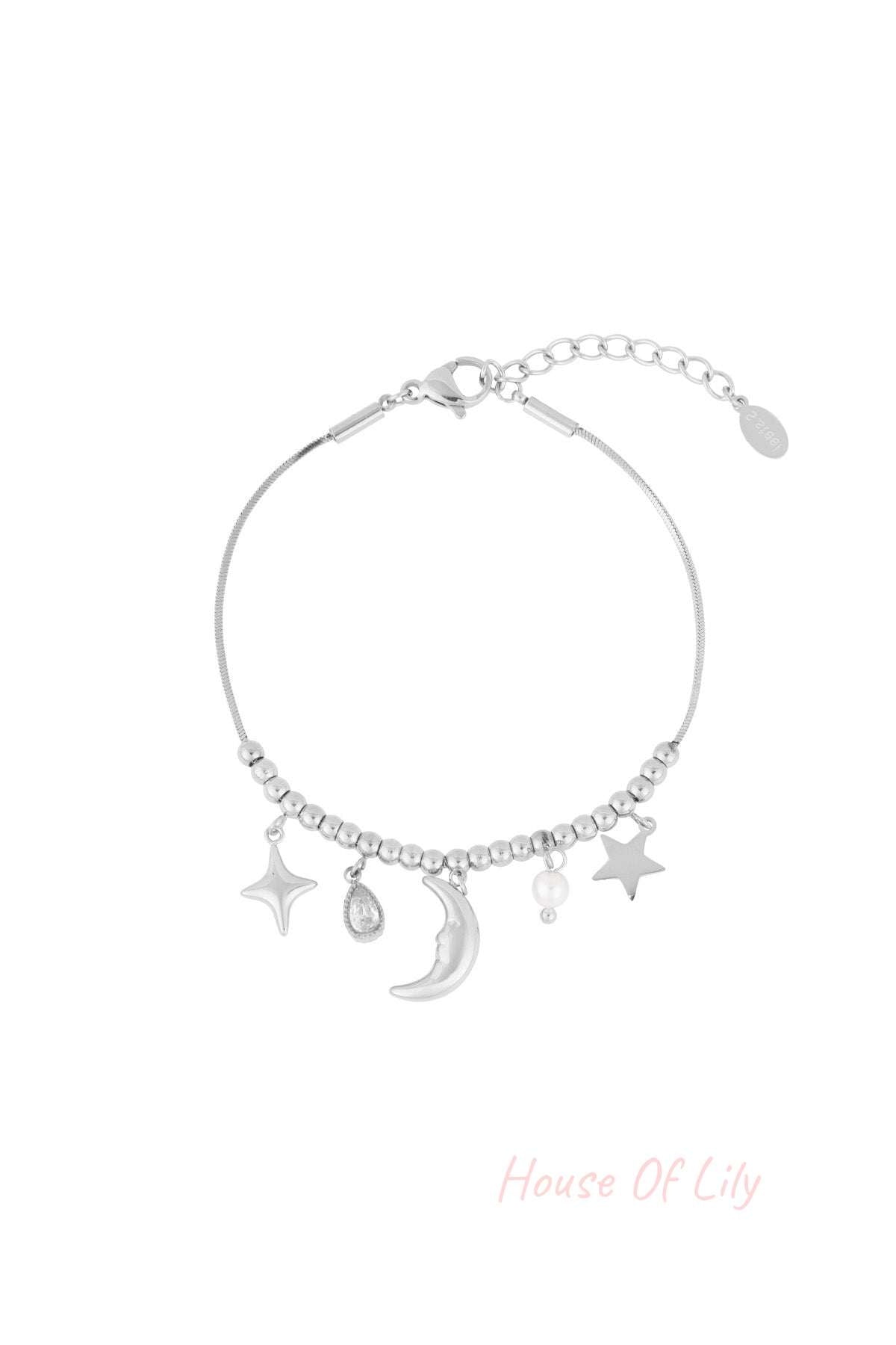 Silver celestial charm bracelet with moon, stars, pearl, and teardrop crystal charms on a beaded chain with adjustable clasp