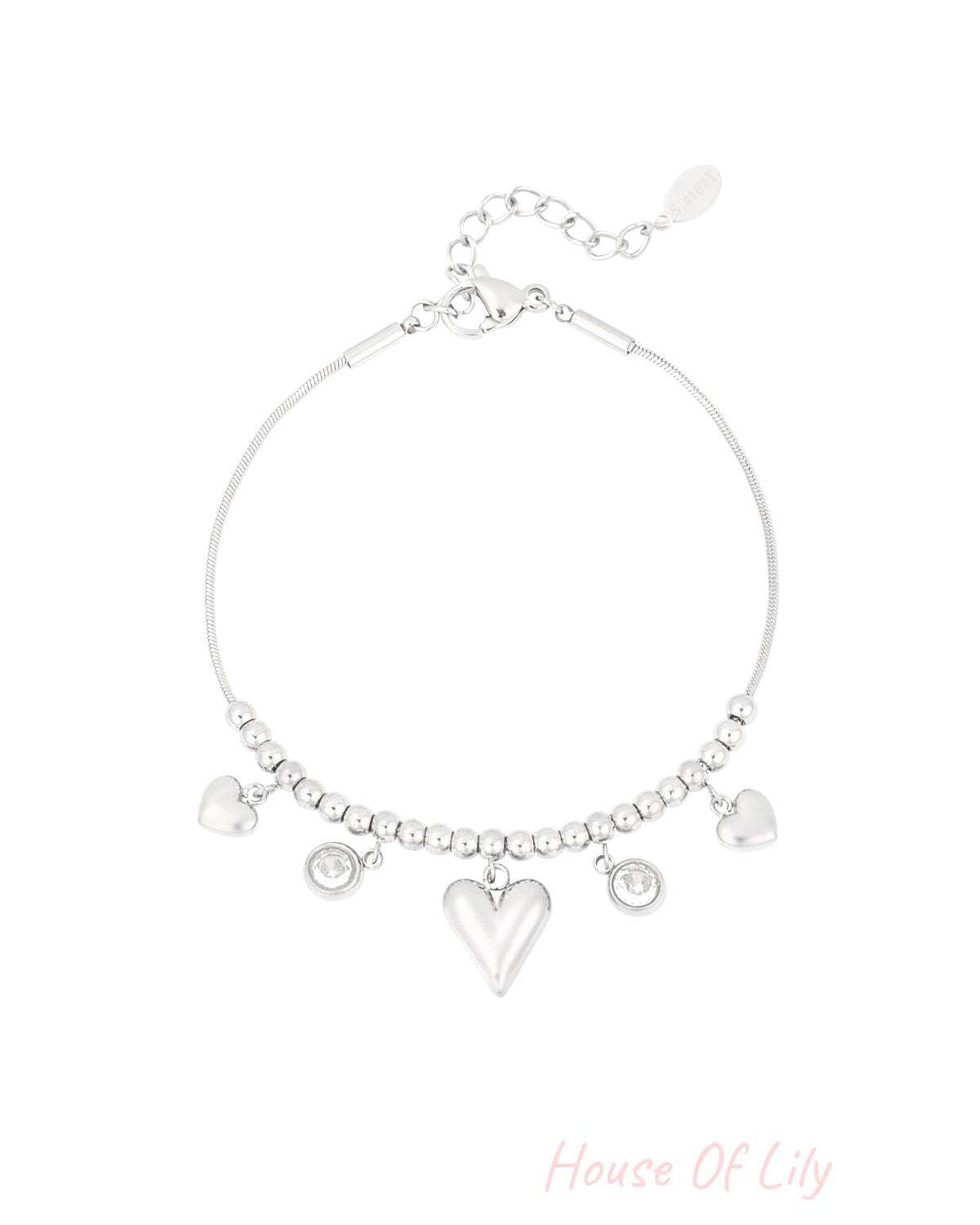 Silver heart bead bracelet with dangling heart charms and crystal accents on white background