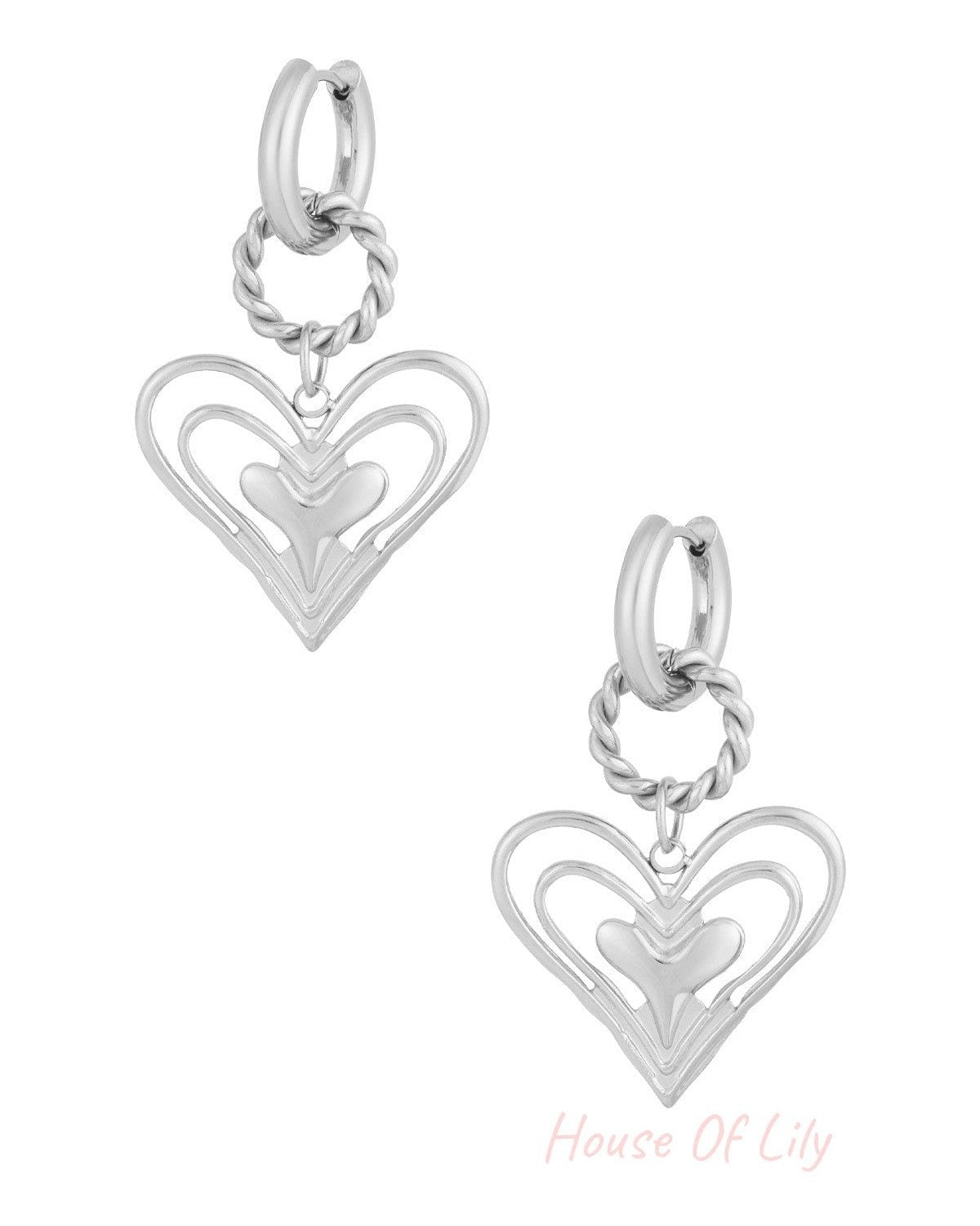 Silver twisted hoop earrings with layered open heart charm on white background