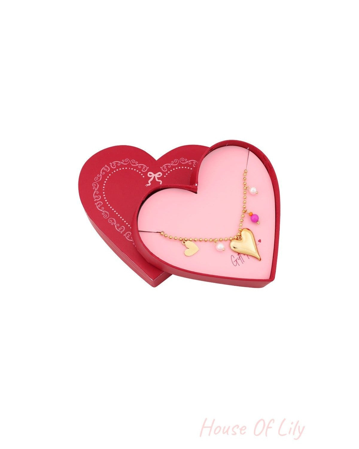 Opened heart-shaped gift box showing gold heart charm bracelet with pearls and pink bead inside
