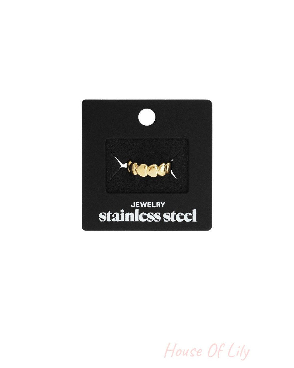 Little Heart Stacker ring in gold-tone stainless steel, featuring a dainty row of small hearts on a black display card.