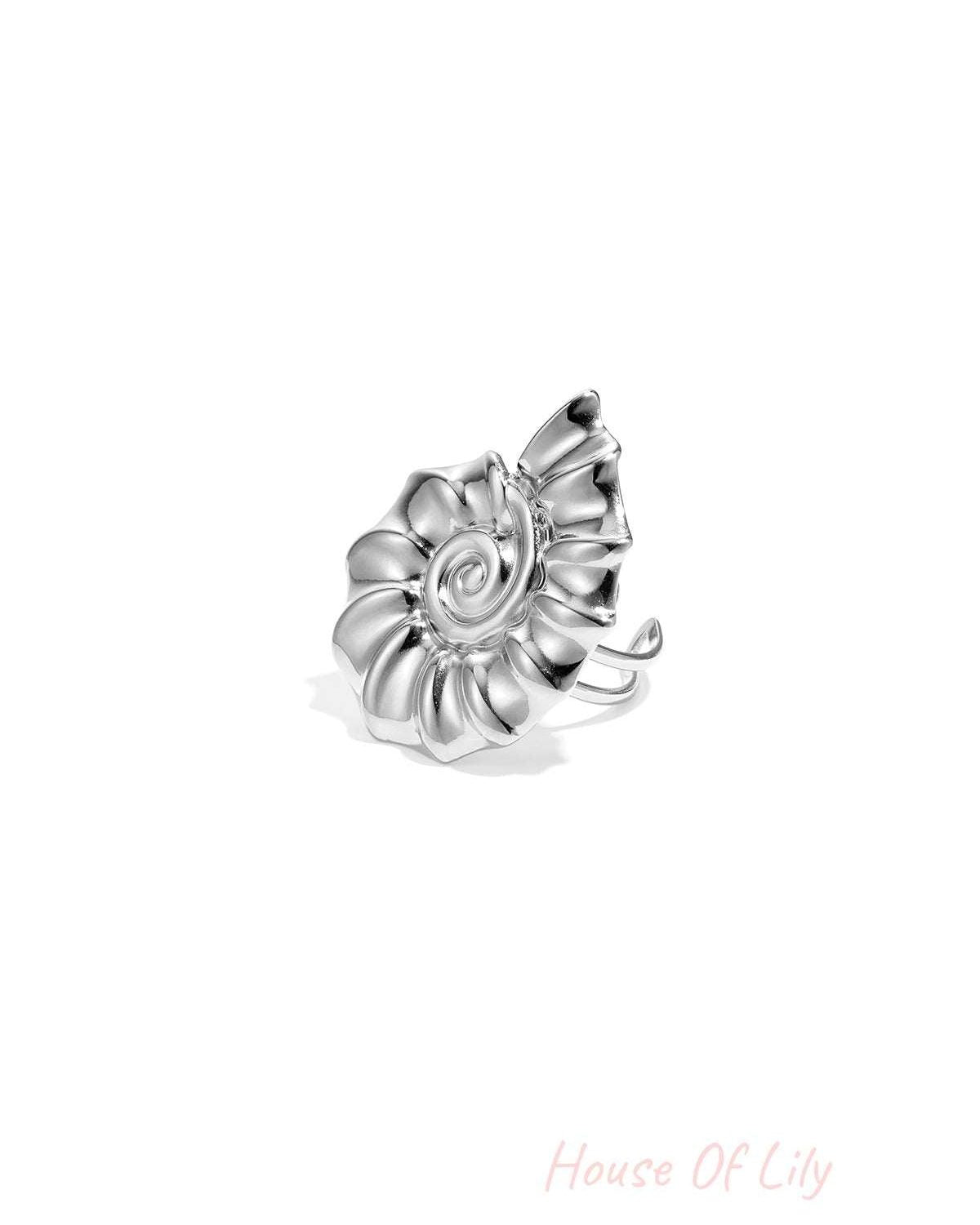 Black and white version of the close-up image of the gold spiral shell statement ring on white background
