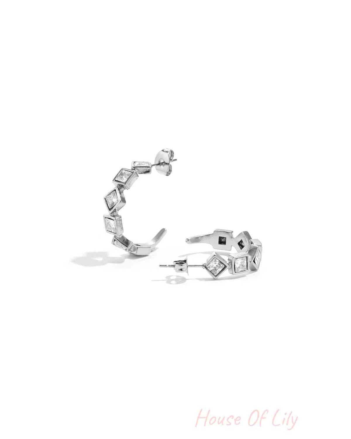 Pair of silver tone square rhinestone hoop earrings displayed on white background